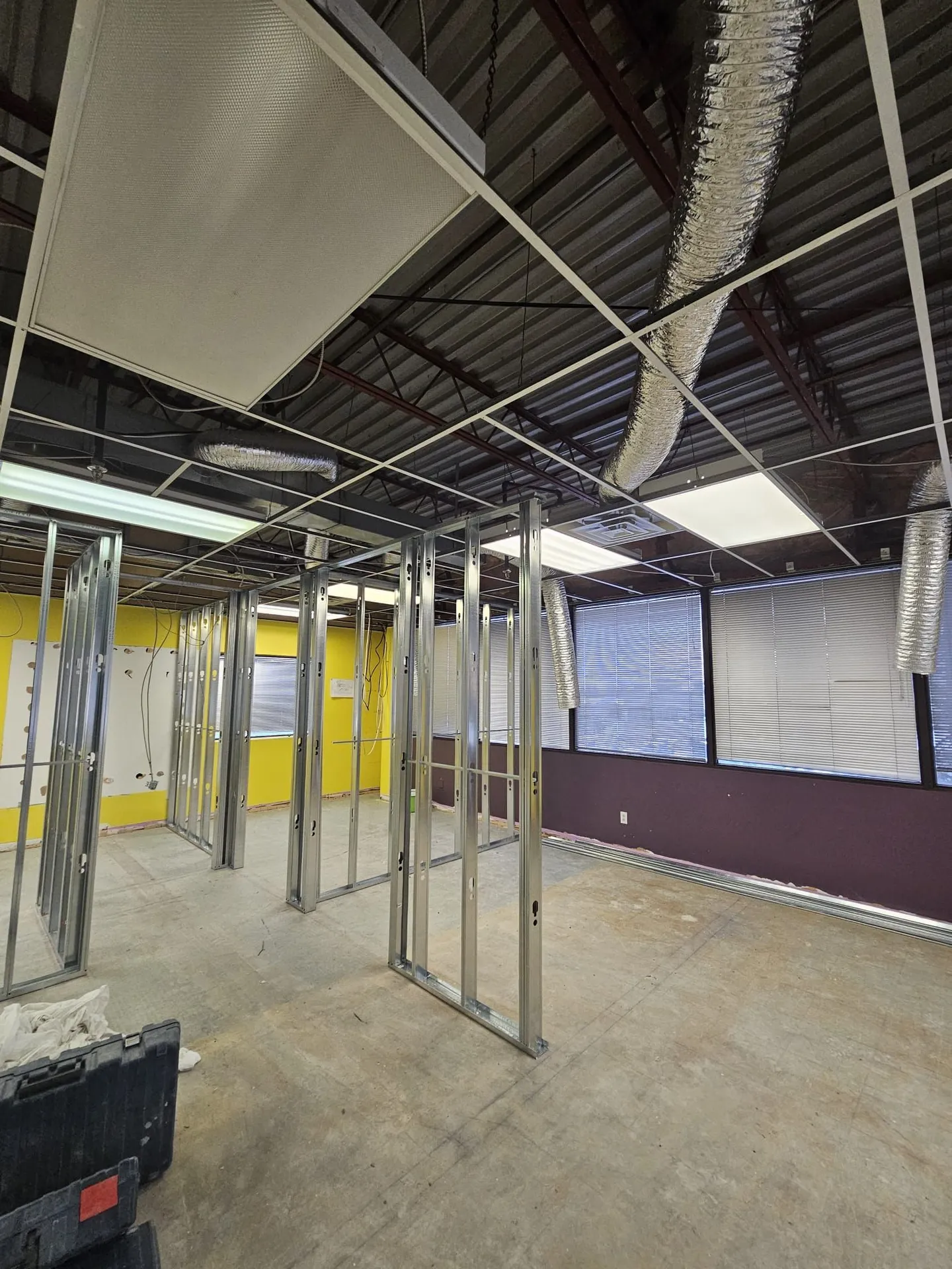 1050 Finch during: steel-stud framing of new offices under the exposed deck