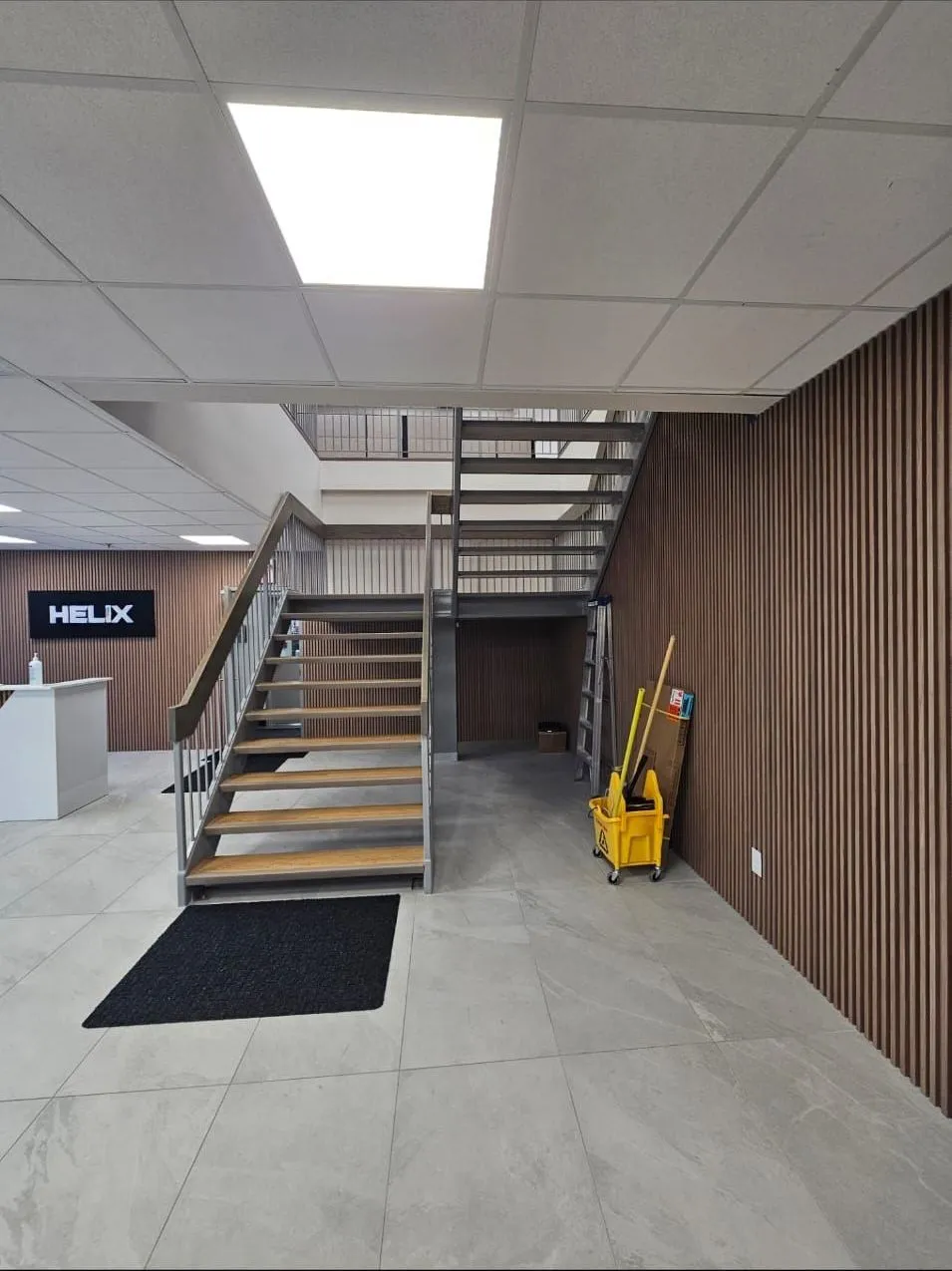 Helix lobby after: new steel staircase with wood treads and slat-wood walls