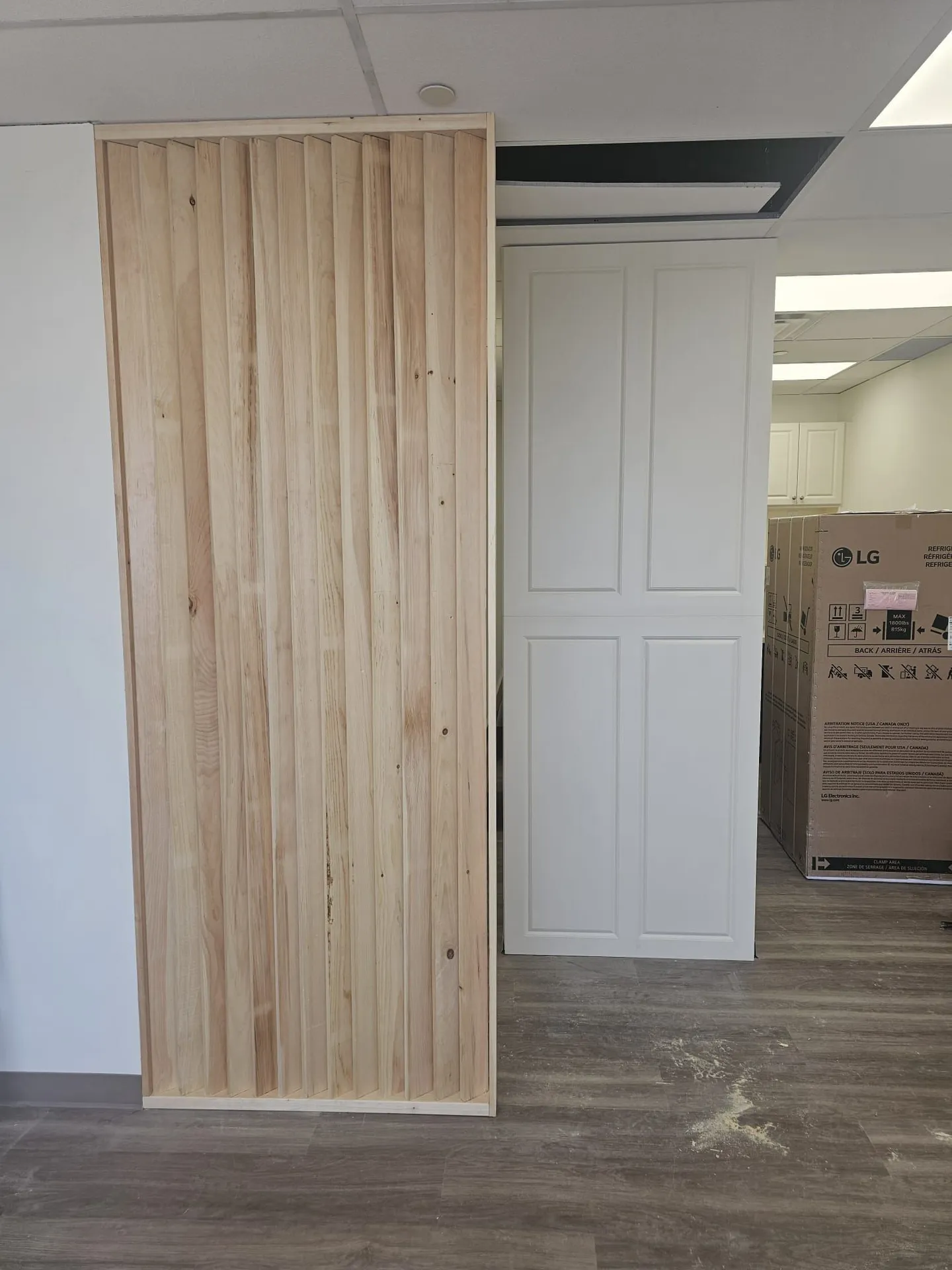 Wood slat feature wall installed beside a white paneled slider