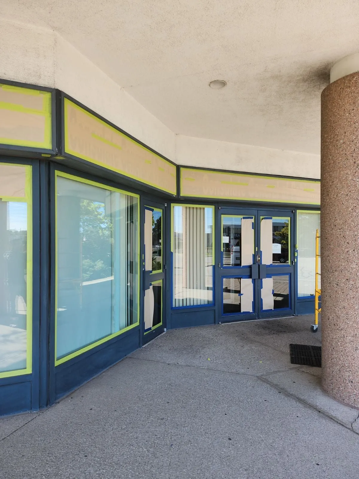 Finished curved storefront entrance with clean navy lines