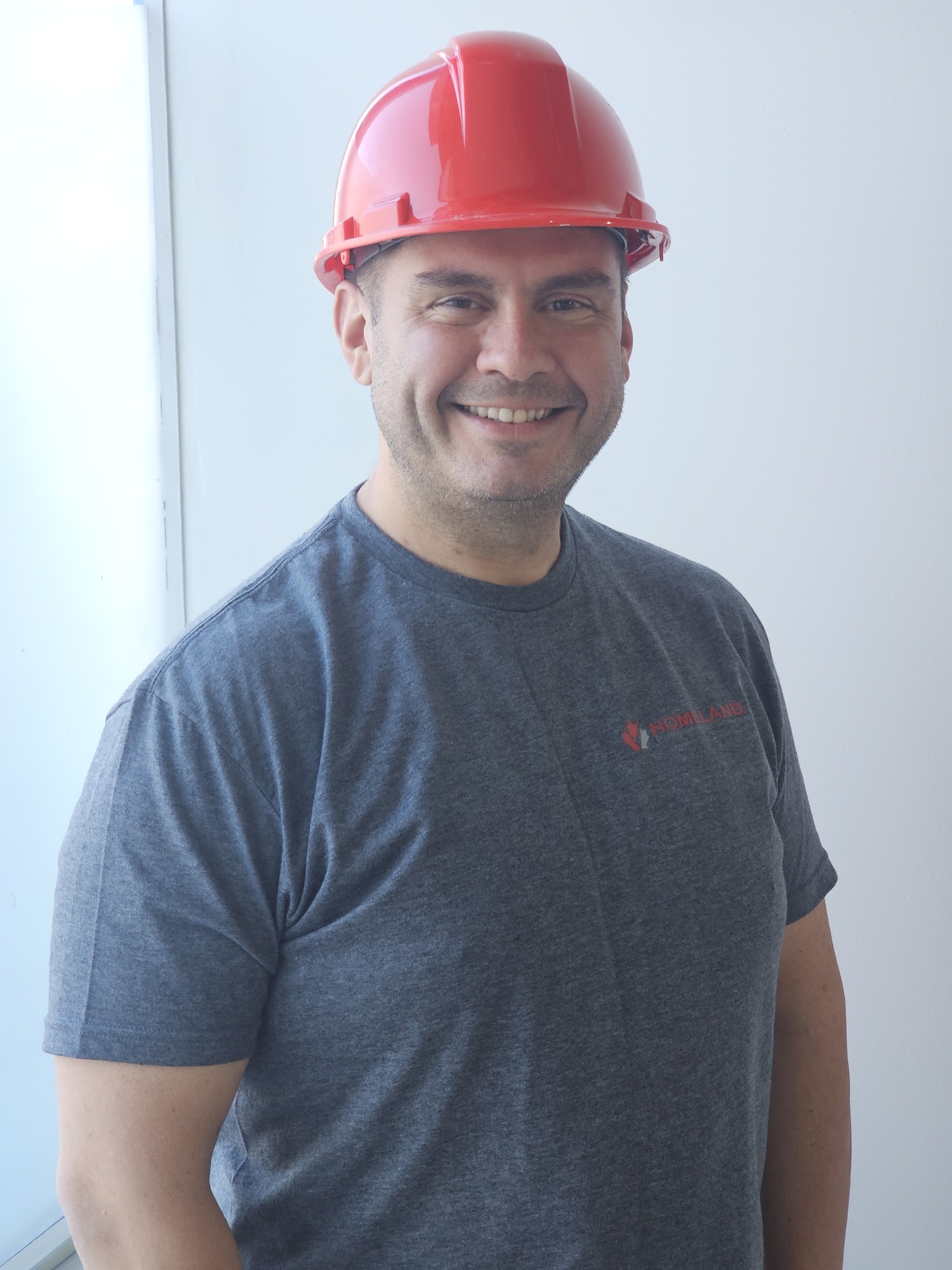 Derek Ferreira wearing a Homeland shirt and red hardhat