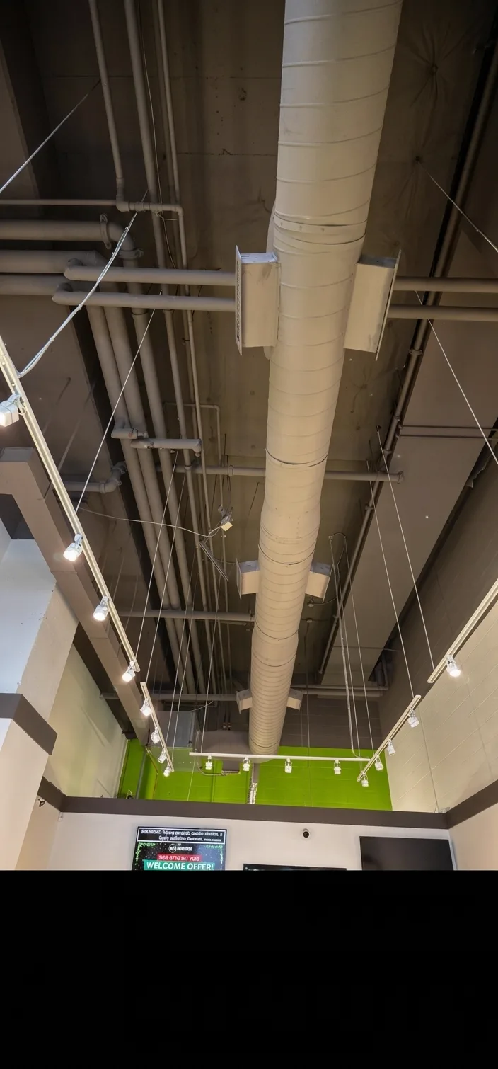 Exposed painted ceiling with new ductwork and suspended track lighting at 180 Smoke
