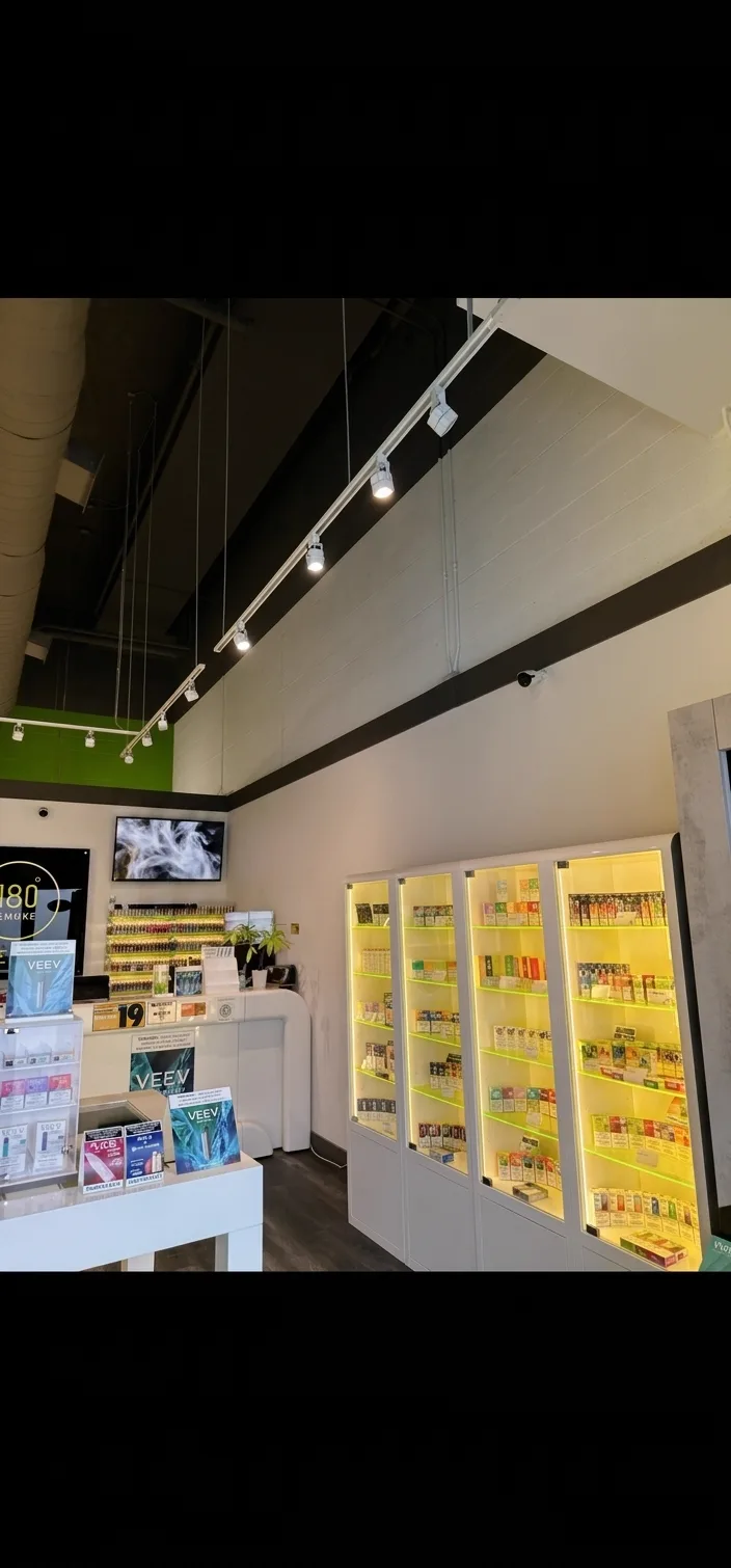 180 Smoke sales floor with backlit display cases and track lighting