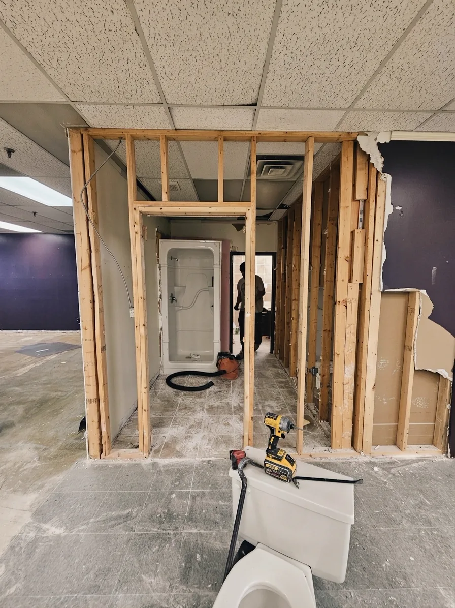 Washroom during: gutted to the studs with new framing up