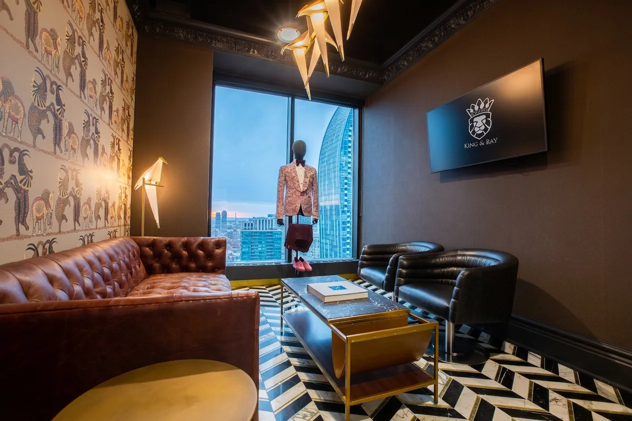 King & Bay client lounge with leather Chesterfield and chevron marble floor