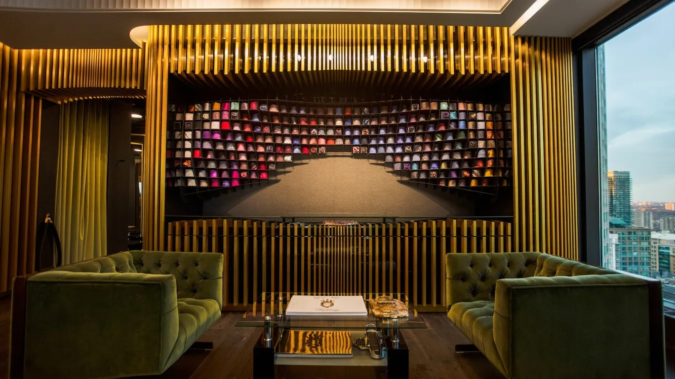 King & Bay tie wall framed in gold slats with velvet lounge seating