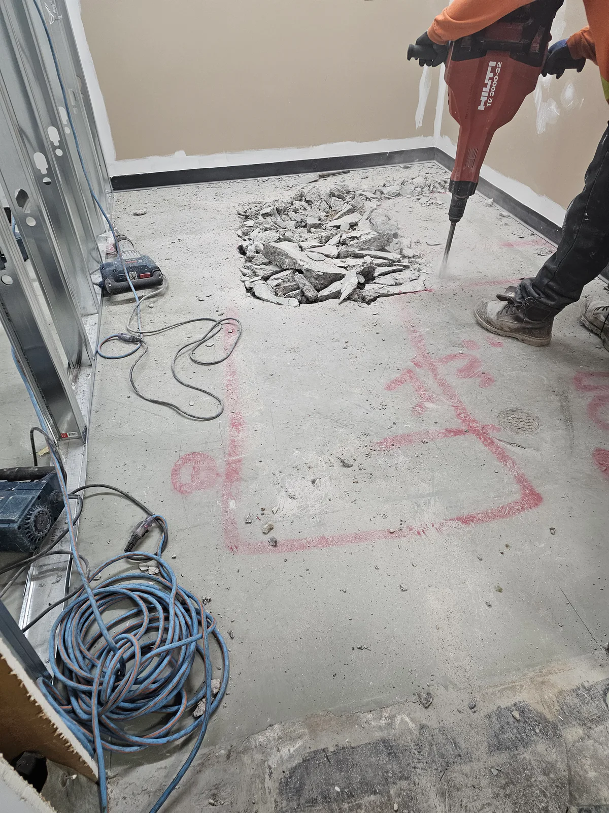 Commercial washroom slab being opened for underground plumbing